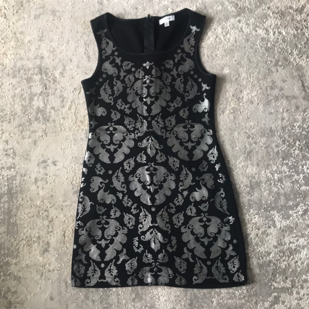 Black dress with silver accents. It shapes perfectly to figure.